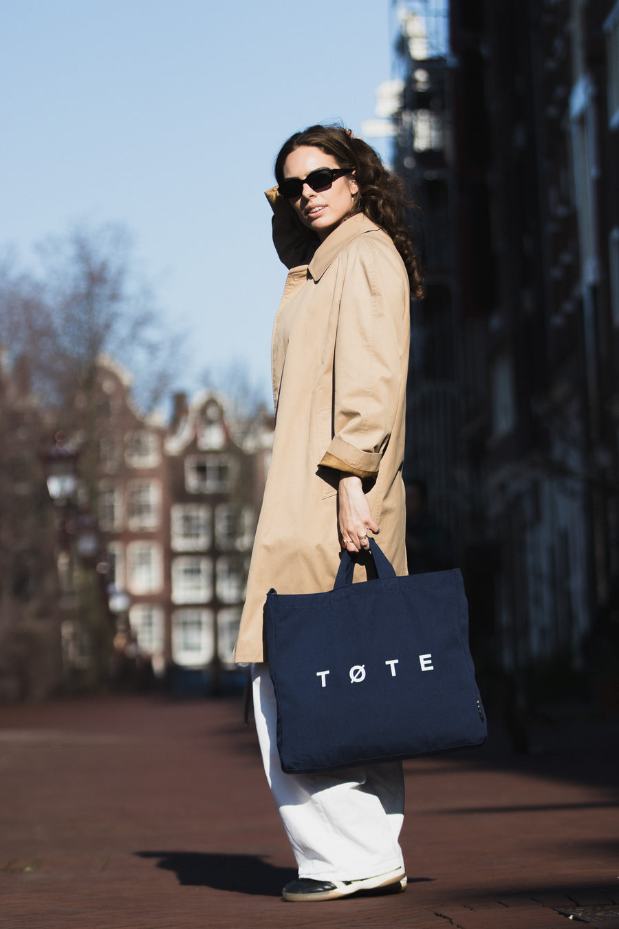 Navy Blue TØTE Bag carried past Amsterdam canal houses